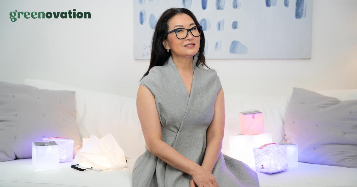 Photo of Solight Design CEO and founder Alice Chun sitting alongside her solar lanterns with the Green Lovers Greenovation logo layered over it